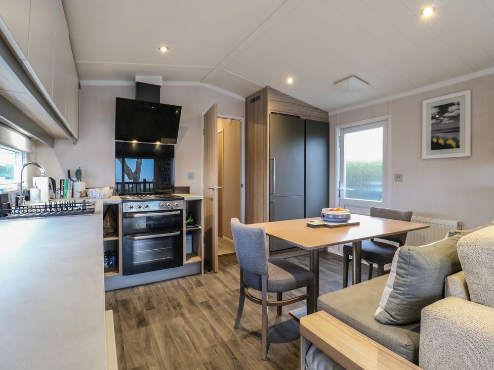 A kitchen with a dining area at no 20 Barley Way in Colchester