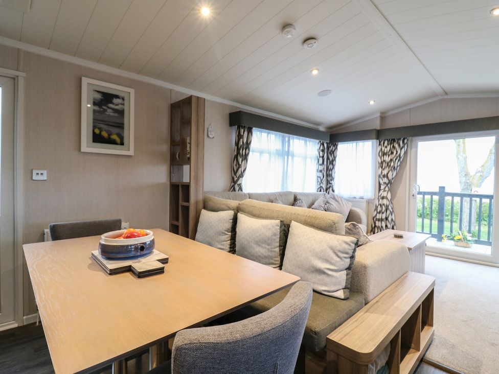A living room with a dining table and sofa at no 20 Barley Way in Colchester