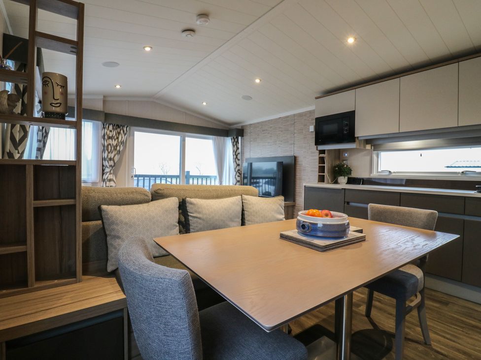 A living room with a dining table and sofa at no 20 Barley Way Colchester