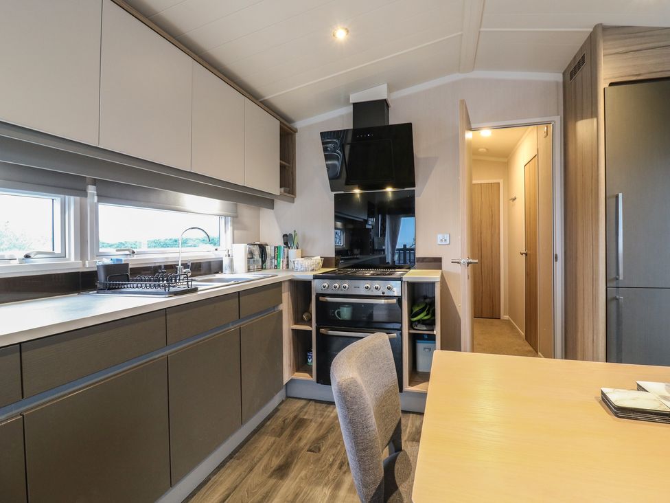 A kitchen with cabinets and appliances at no 20 Barley Way Colchester