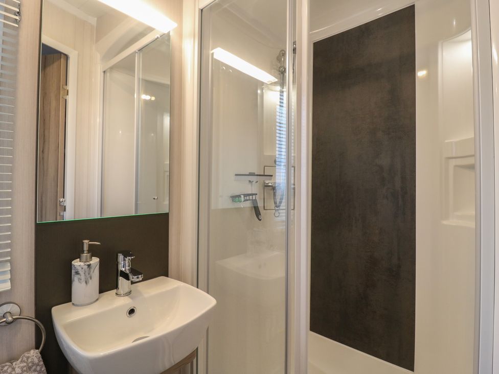 A bathroom with a sink and a shower at no 20 Barley Way Colchester