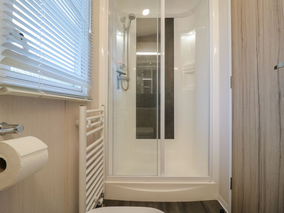 A bathroom with shower, toilet, and towel rail at no 20 Barley Way Colchester