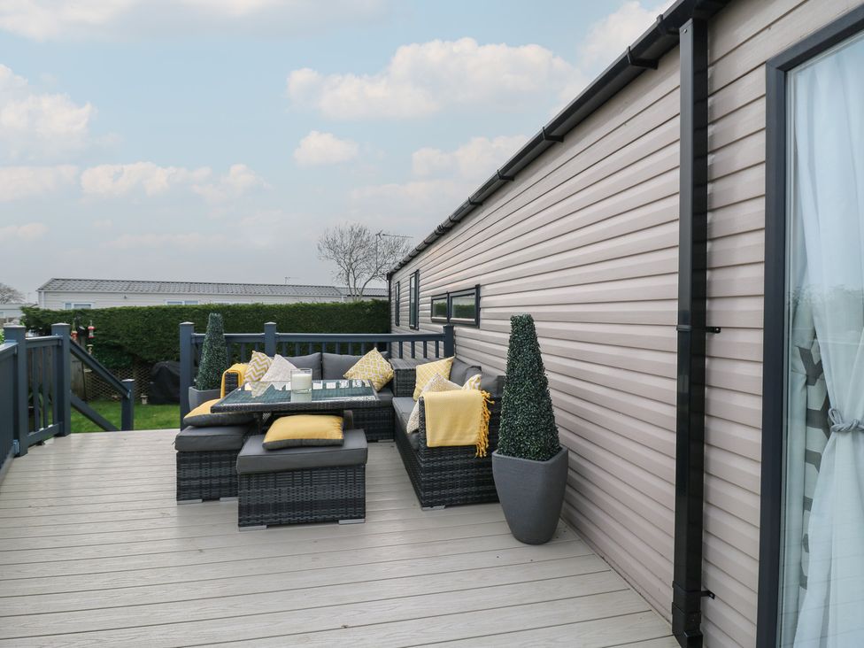 A deck with outdoor furniture and plants at no 20 Barley Way in Colchester