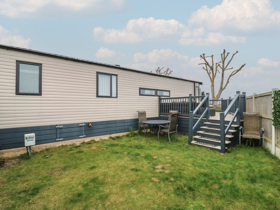 A mobile home with steps and seating area at no 20 Barley Way in Colchester