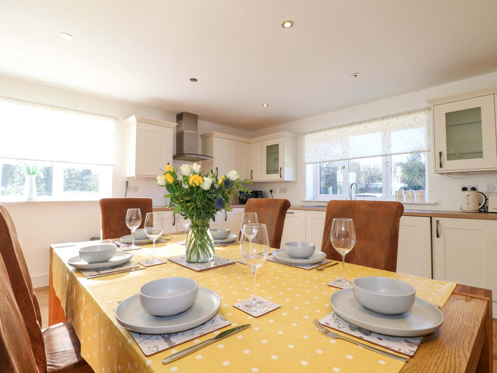 A kitchen with a dining table set for meals at Snowdrop Cottage in Maidstone