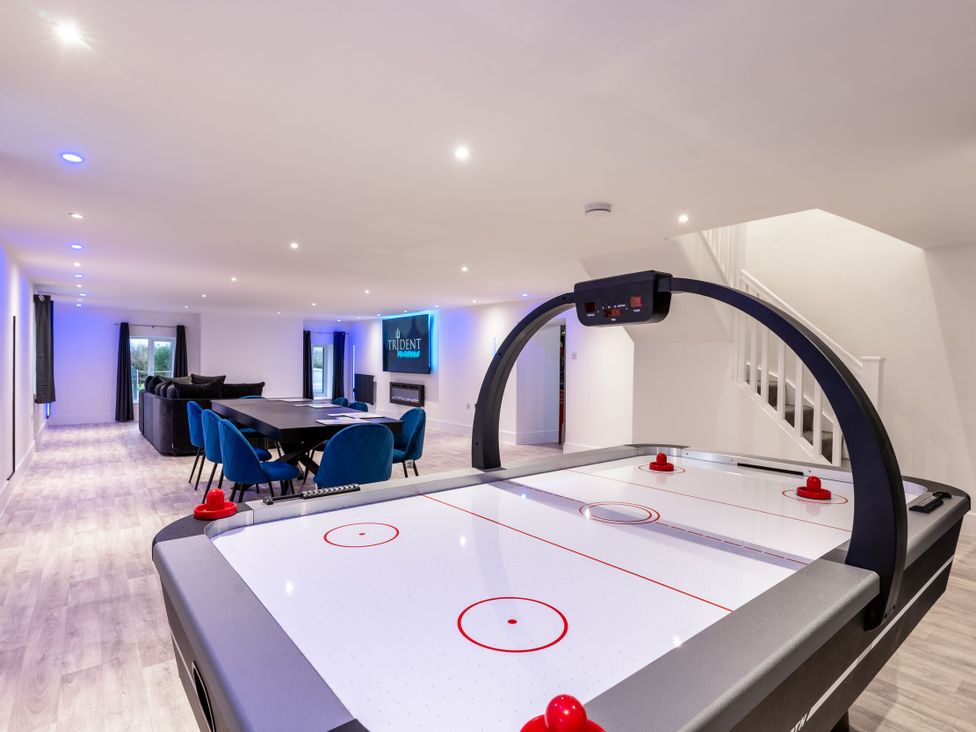 A game room with an air hockey table and dining area at Manor Farm in Glastonbury