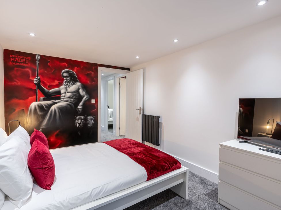 A bedroom with a bed and television at Manor Farm in Glastonbury