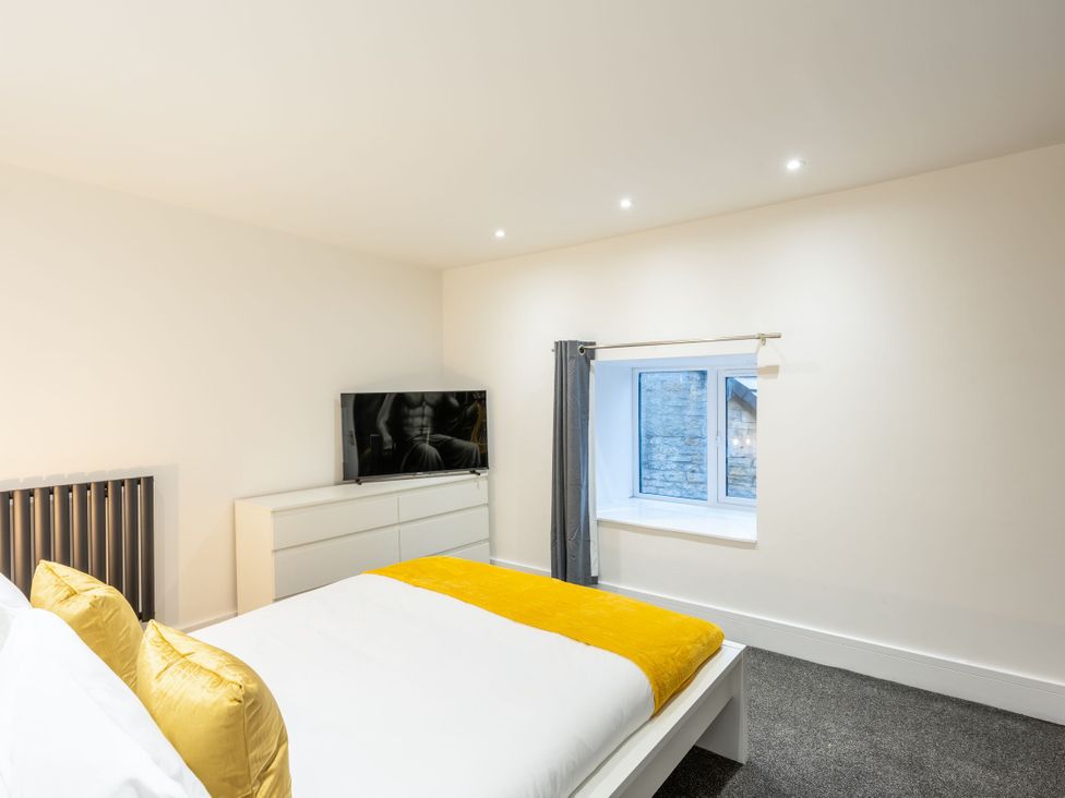 A bedroom with a bed and television at Manor Farm in Glastonbury