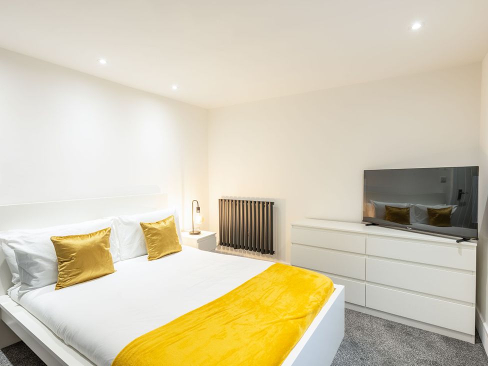 A bedroom with a bed and television at Manor Farm in Glastonbury
