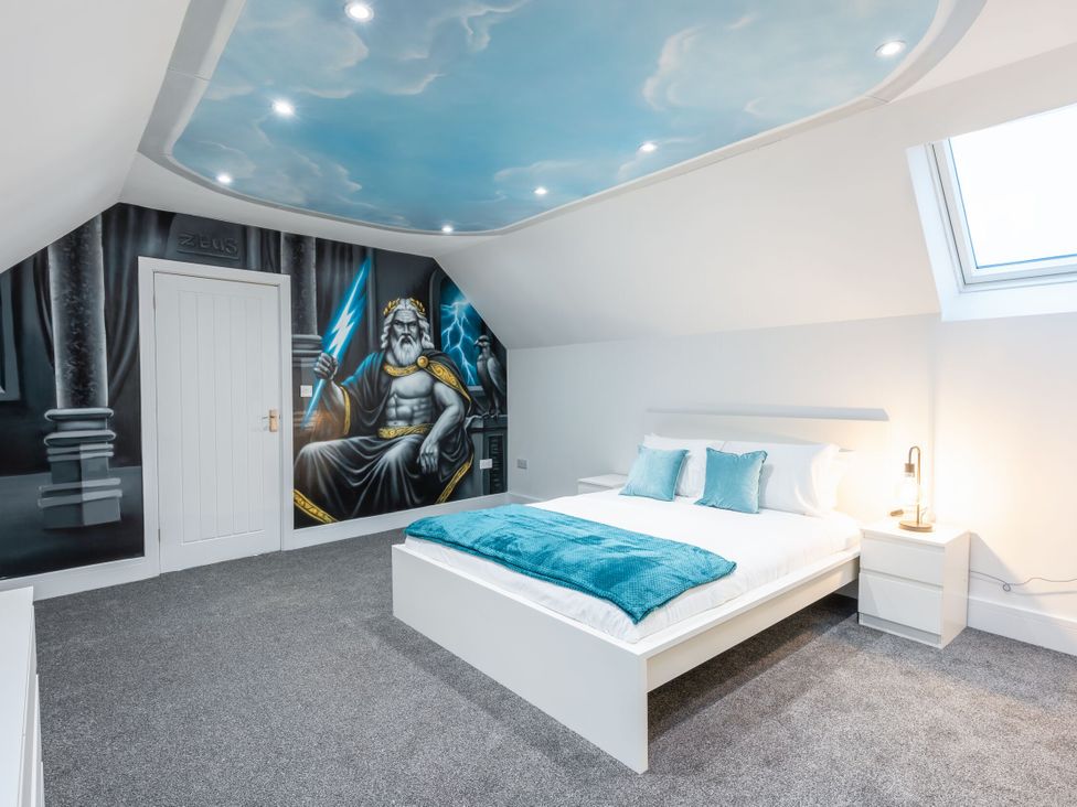 A bedroom with a bed and a mural of Zeus at Manor Farm in Glastonbury