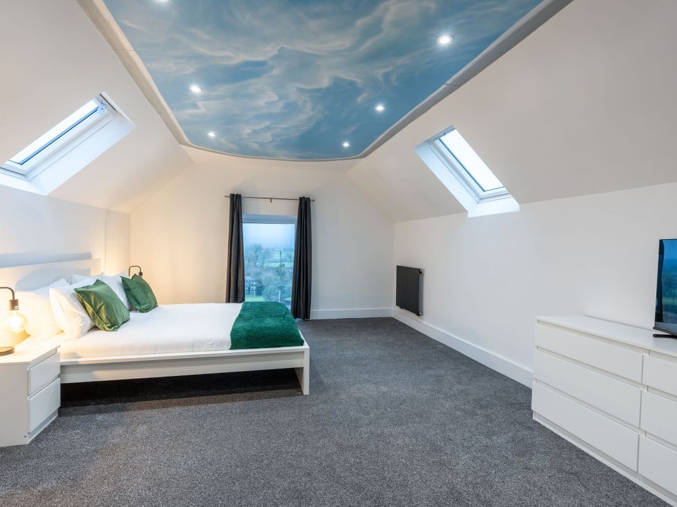 A bedroom with a bed and television at Manor Farm in Glastonbury