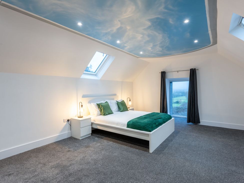 A bedroom with a bed and a window at Manor Farm in Glastonbury