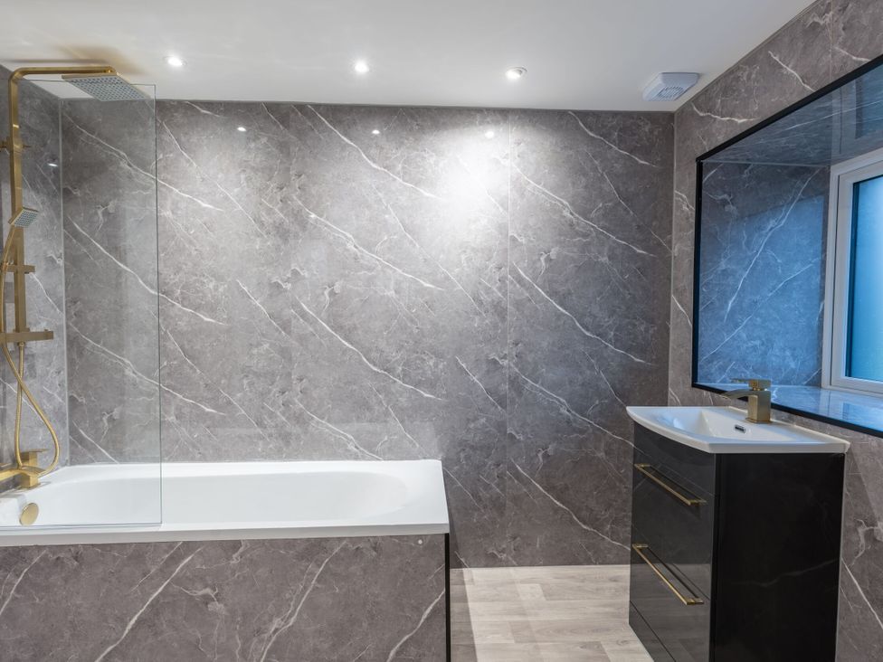 A bathroom with a bathtub, shower, sink at Manor Farm in Glastonbury
