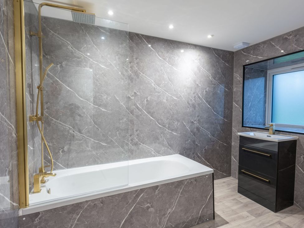 A bathroom with a bathtub and shower at Manor Farm in Glastonbury