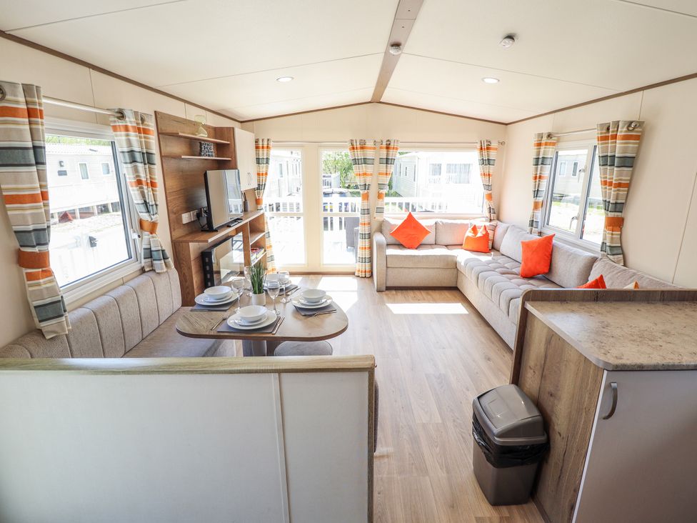 A living room with a sofa and table at 39 Larch View with hot tub in Tattershall