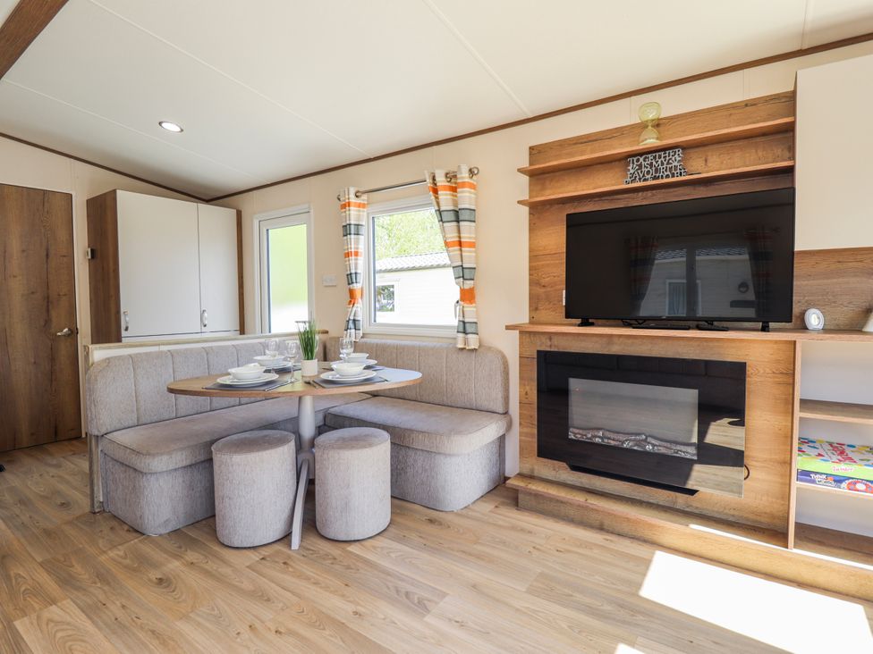 A dining area with a table and chairs at 39 Larch View with hot tub Tattershall