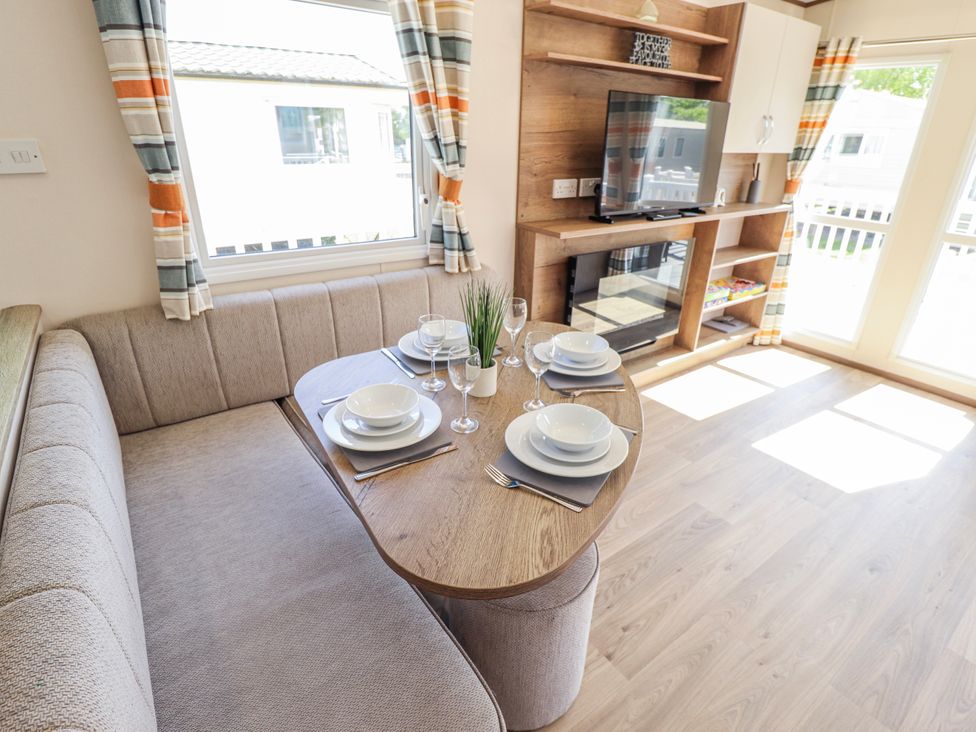 A dining area with a table set for four at 39 Larch View with hot tub Tattershall