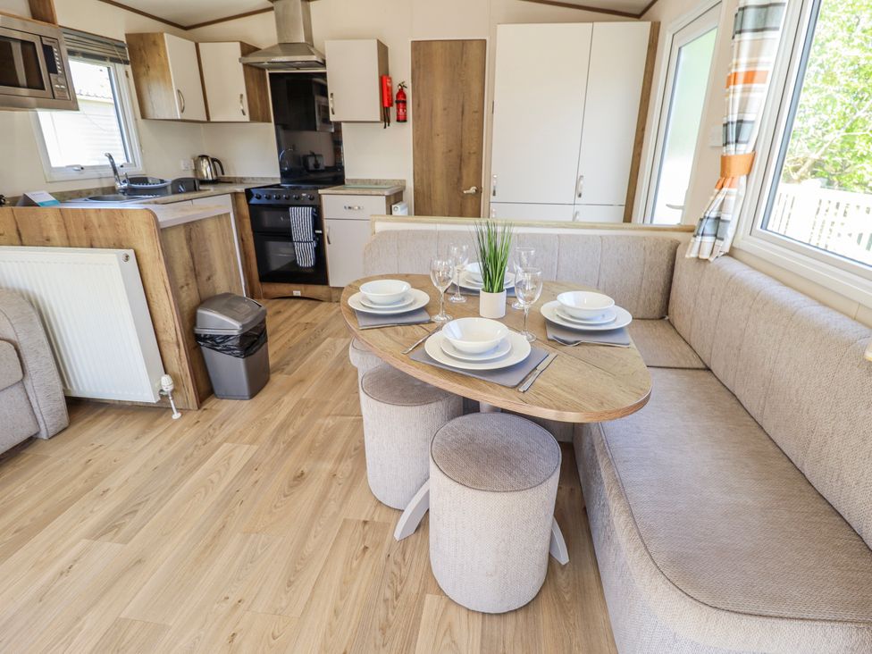A dining area with table and chairs at 39 Larch View with hot tub Tattershall
