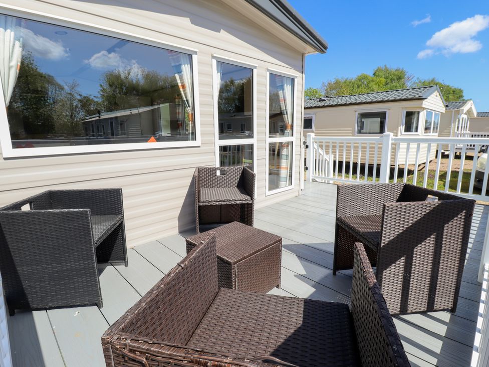 An outdoor seating area with wicker furniture at 39 Larch View with hot tub Tattershall