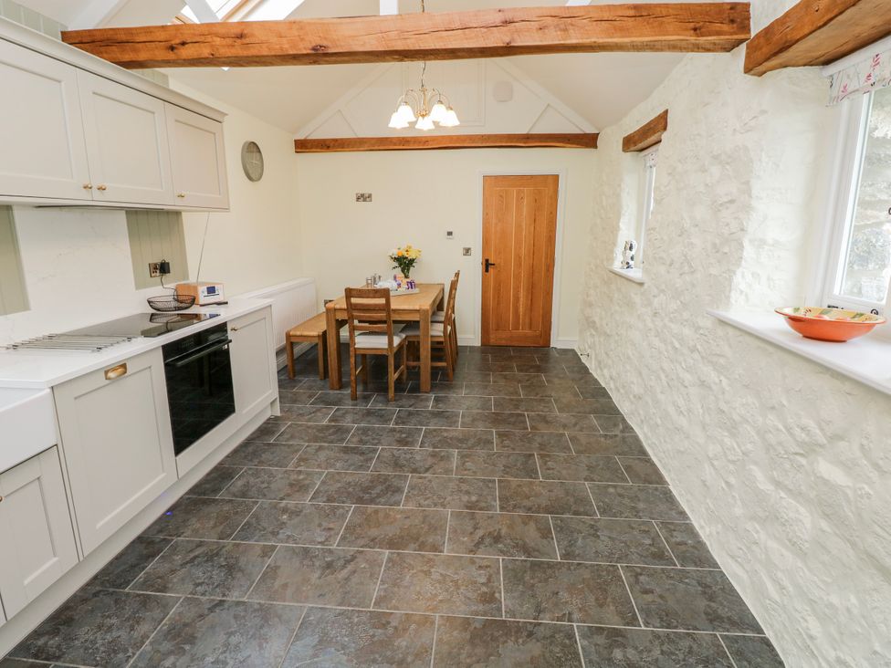 A kitchen with dining area at Barley Cottage in Oxwich