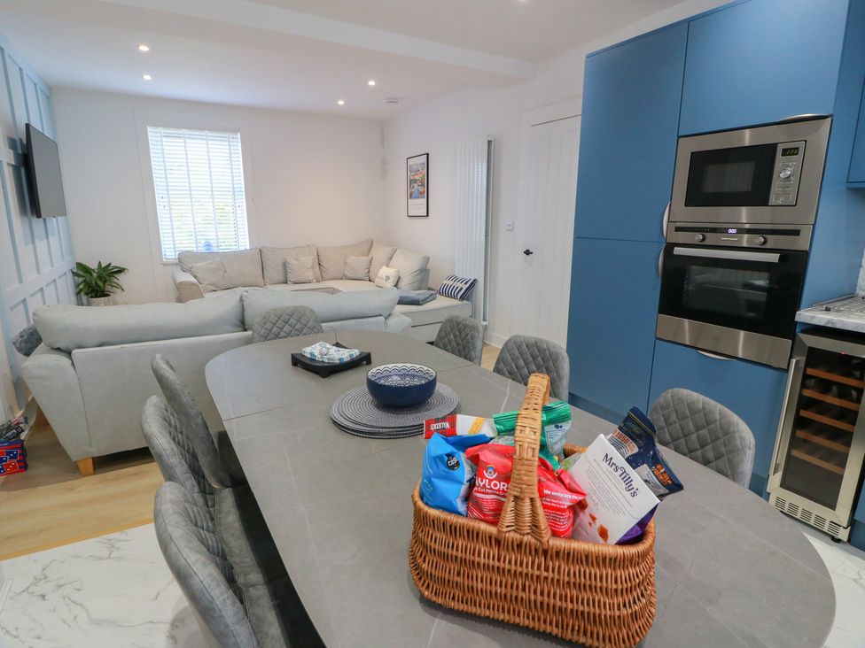 A kitchen with a table and a sofa at Olea in Portpatrick