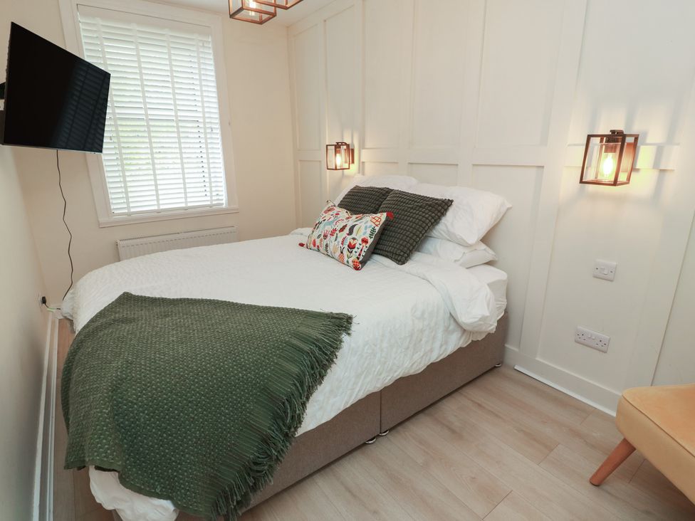 A bedroom with a bed and television at Olea Portpatrick