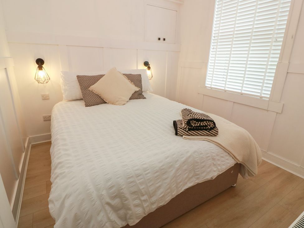 A bedroom with a bed and pillows at Olea Portpatrick
