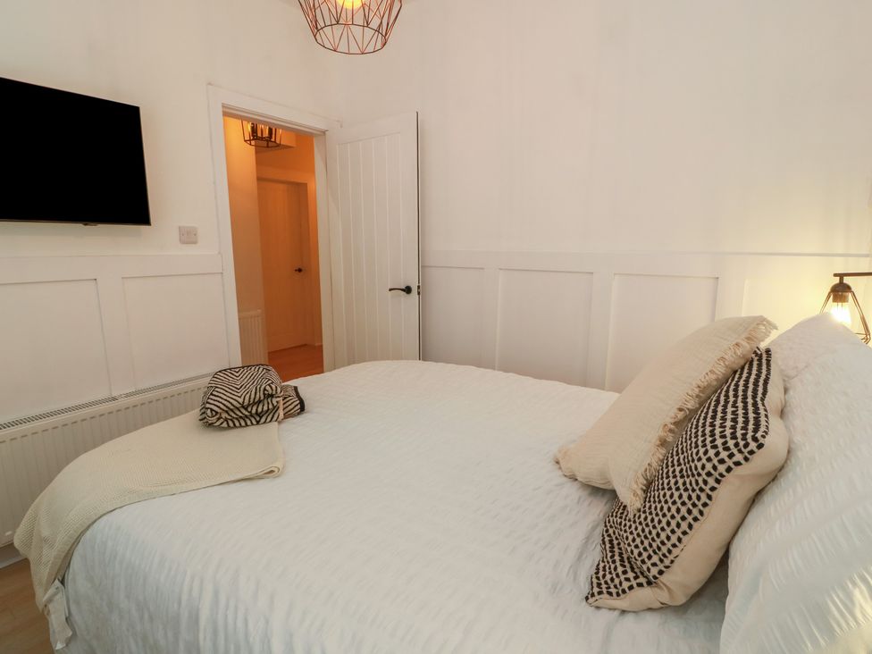 A bedroom with a bed and television at Olea Portpatrick