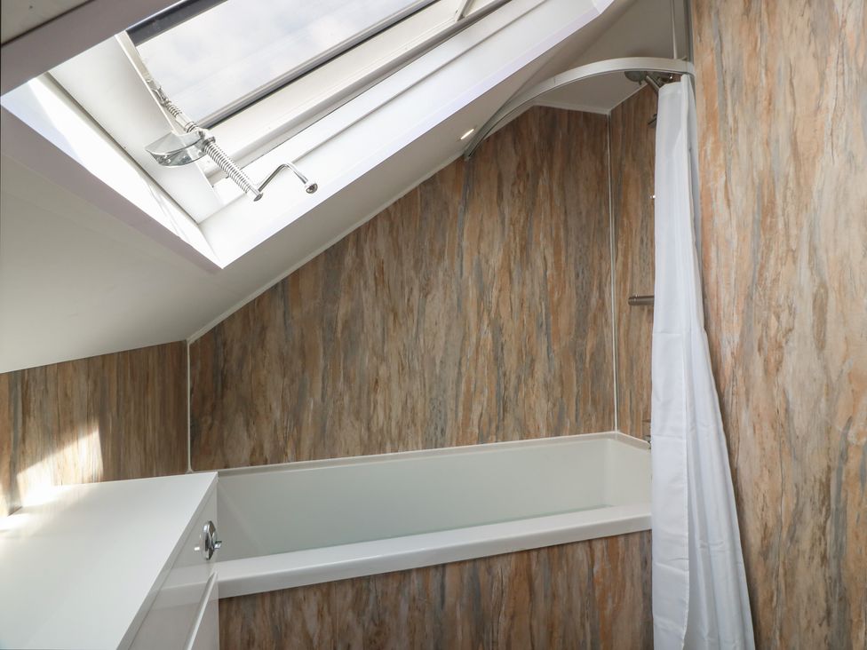 A bathroom with a bathtub and shower at Olea in Portpatrick