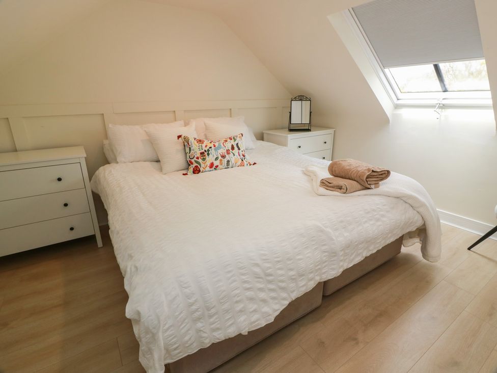 A bedroom with a bed and nightstands at Olea Portpatrick