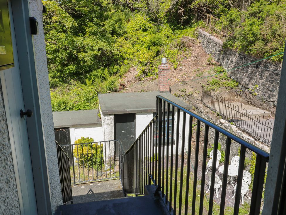 View from stairs showing a building and garden area at Olea Portpatrick