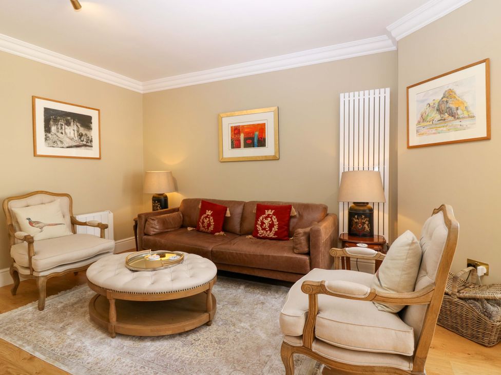 A living room with a sofa and armchairs at Woodmarket Apartments in Kelso