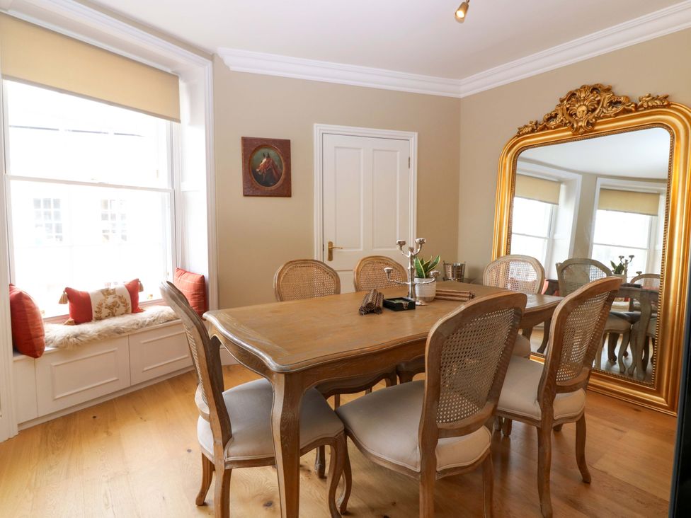 A dining area with a table and chairs at Woodmarket Apartments in Kelso