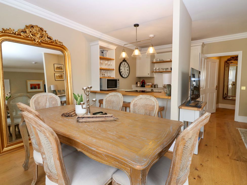 A dining room with a table and chairs at Woodmarket Apartments in Kelso
