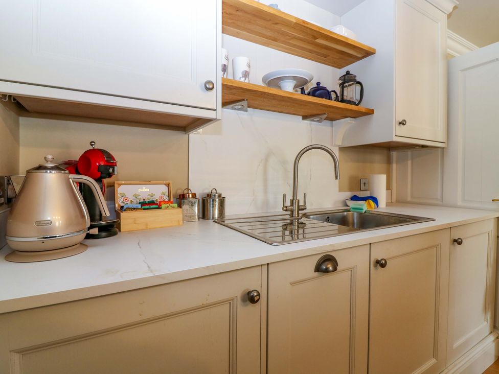A kitchen with a kettle and coffee machine at Woodmarket Apartments in Kelso