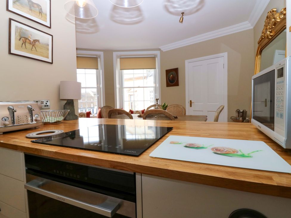 A kitchen with a cooktop and toaster at Woodmarket Apartments in Kelso