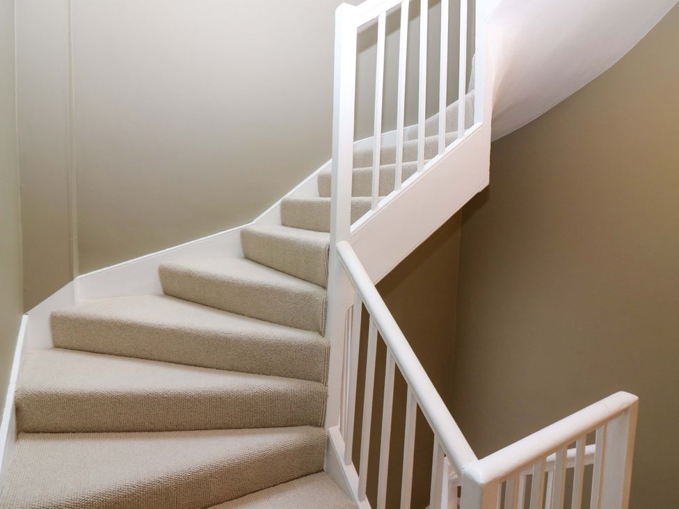 Stairs with a carpet and banister at Woodmarket Apartments in Kelso
