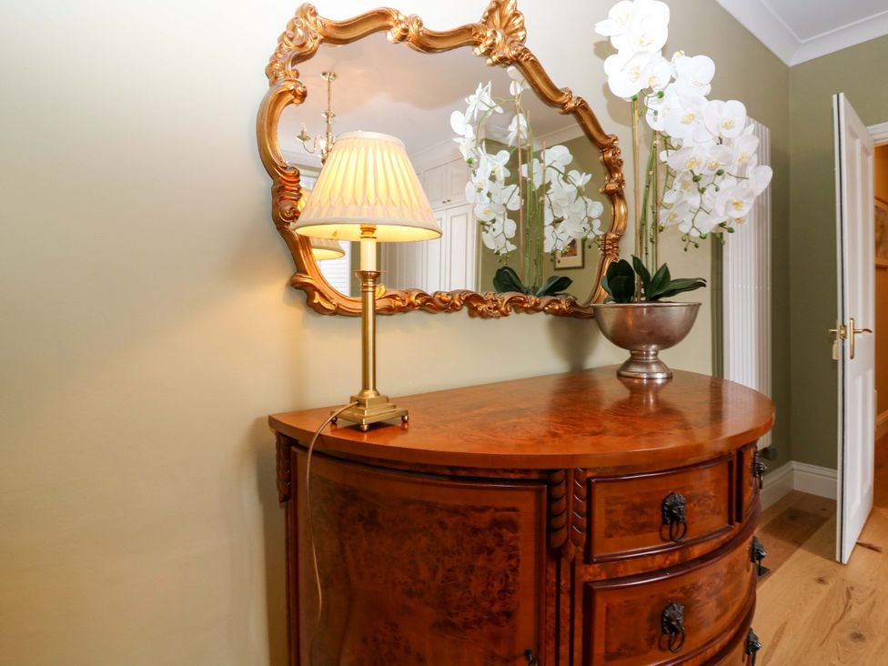 A hallway with a table and lamp at Woodmarket Apartments in Kelso