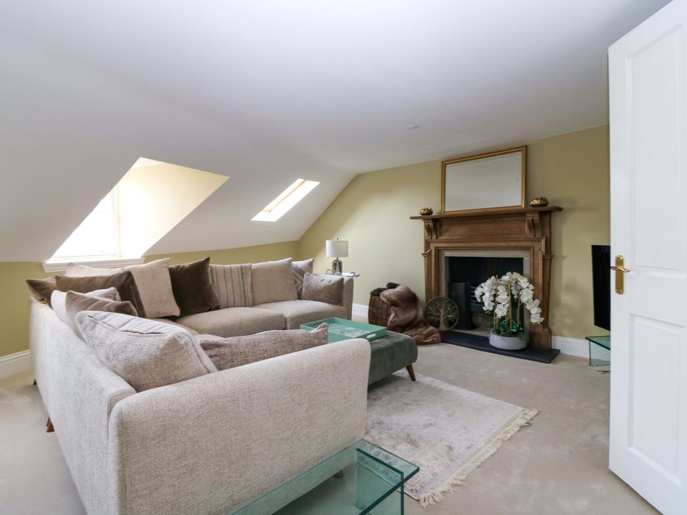 A living room with a sofa and fireplace at Woodmarket Apartments in Kelso
