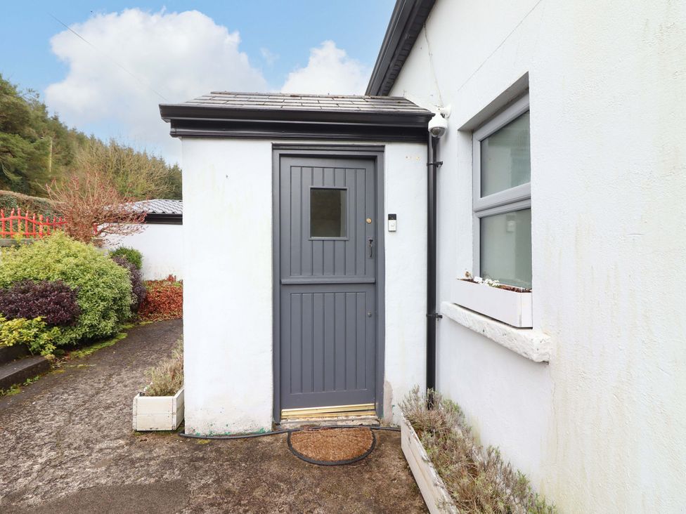 An entrance with a gray door and plants at Turraheen in Cashel