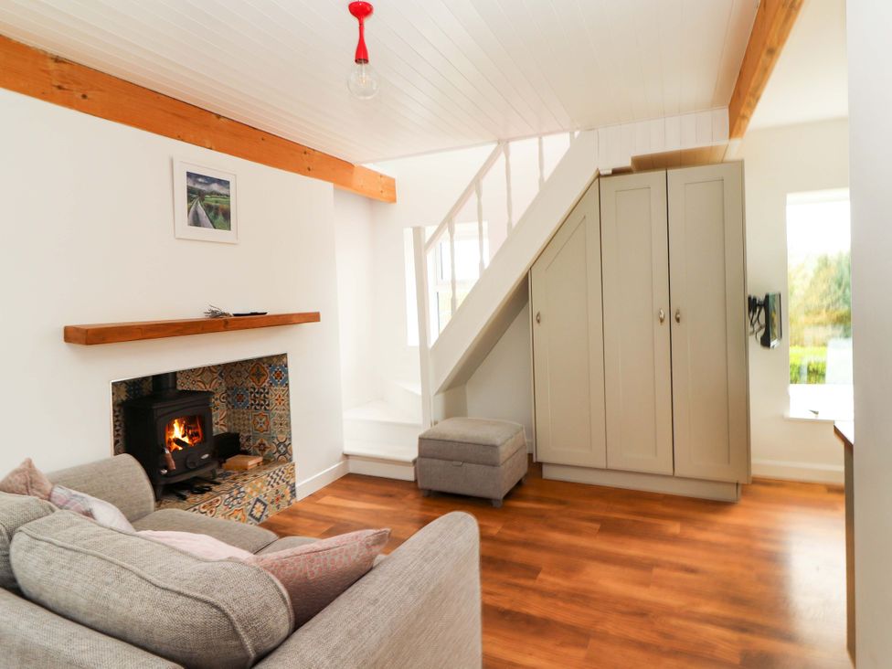 A living room with a sofa and fireplace at Turraheen in Cashel