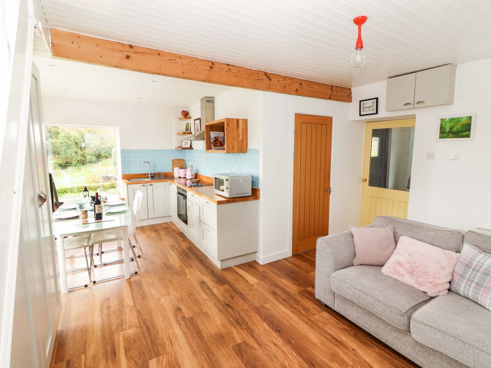 A kitchen with dining area and sofa at Turraheen in Cashel