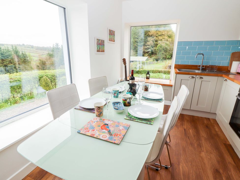 A dining room with a table set for dinner at Turraheen Cashel
