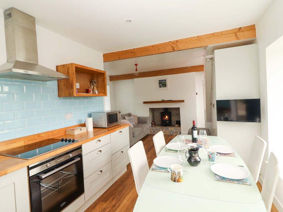 A kitchen with a dining area and an island at Turraheen in Cashel