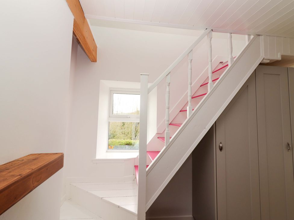 A staircase with a window and cupboards at Turraheen in Cashel