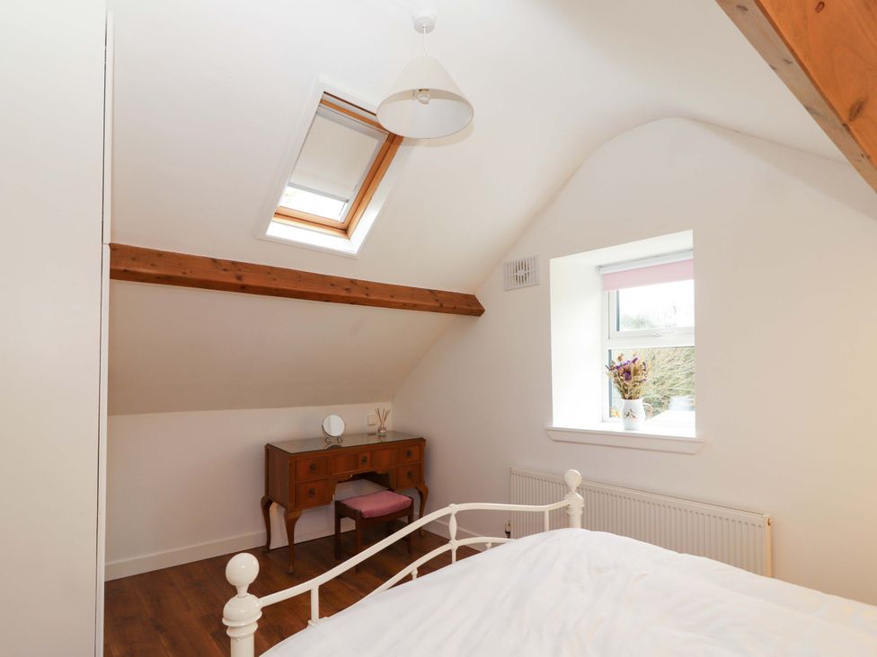 A bedroom with a bed and a desk at Turraheen in Cashel