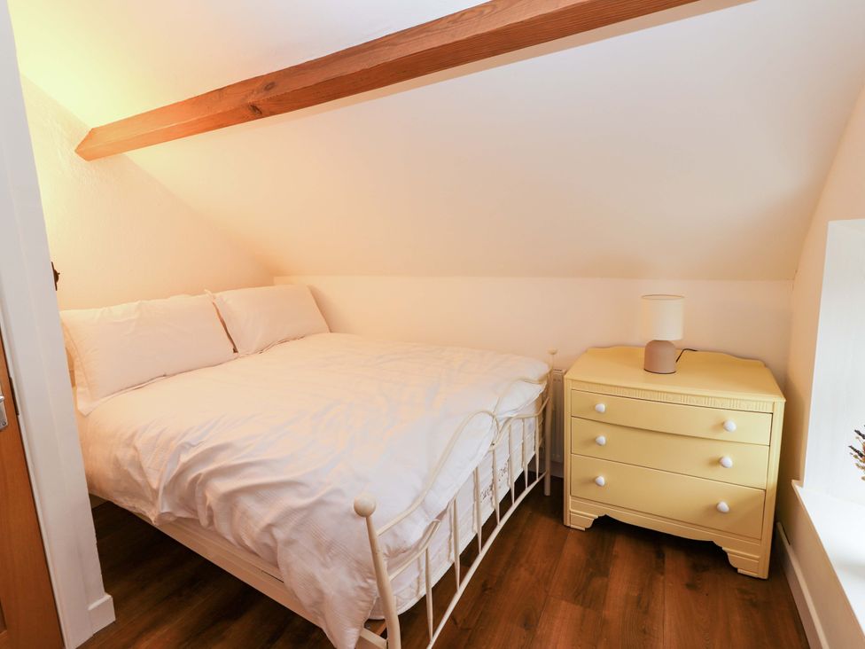 A bedroom with a bed and a nightstand at Turraheen in Cashel