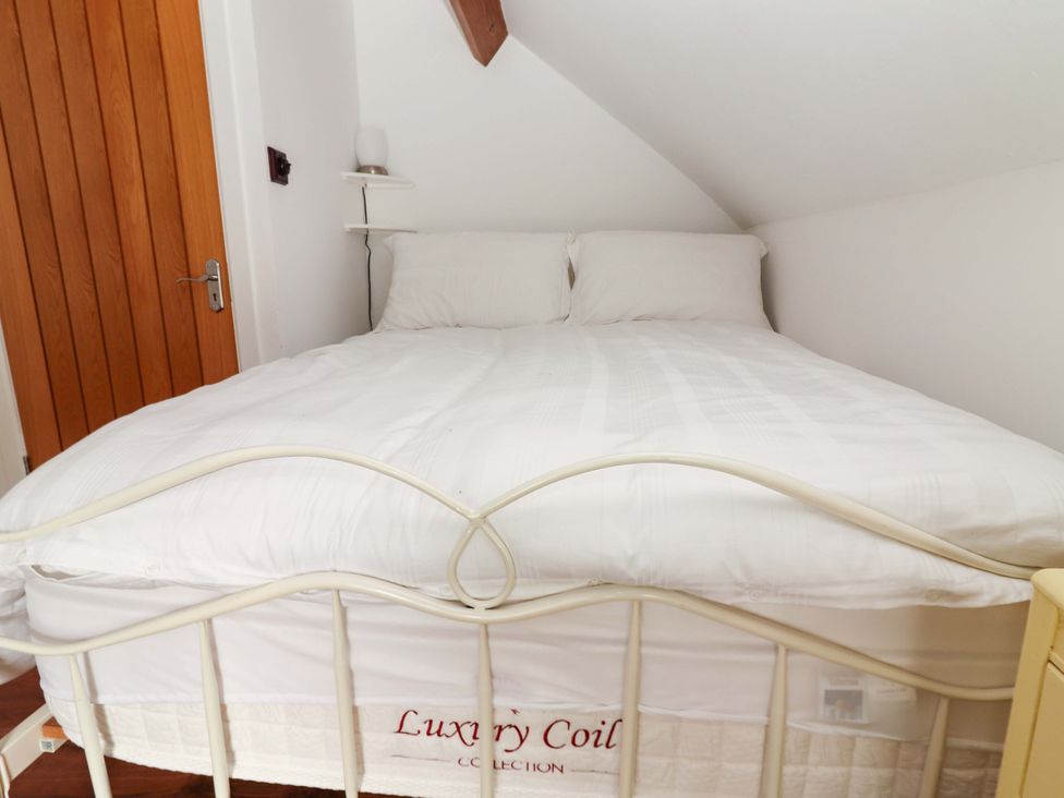 A bed with white bedding and pillows at Turraheen in Cashel