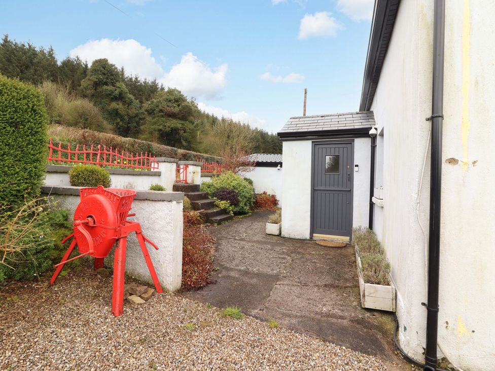 An outdoor path leading to a door with a garden feature at Turraheen in Cashel