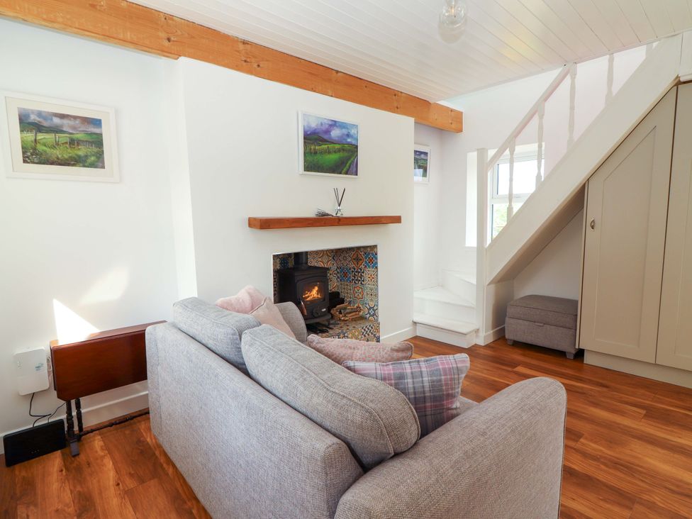 A living room with a sofa and fireplace at Artist’s Cottage Cashel, County Tipperary